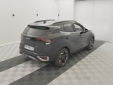 the rear end of a grey car parked in a garage