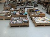 many boxes of books on the floor in a large room