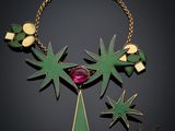 a close up of a necklace on a black background