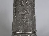 an antique silverware vase with an image of a woman holding a child