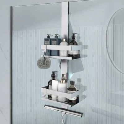 a glass shower door with a shelf with soaps and lotions