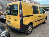 a yellow van that is parked in a parking lot