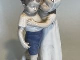 a figurine of a couple hugging each other