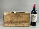 a wooden box with a bottle of wine next to it
