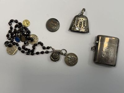 a silver lighter and a rosary with a coin