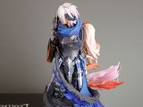 a figurine of a woman with a sword on top of a book