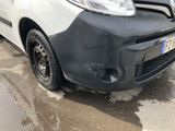 a car that has been badly damaged and is parked on the side of the road