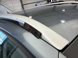 a close up of a car with a clock on the roof