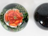 three oval shaped stones with different designs on them on a white surface