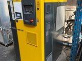 an image of a yellow machine in a warehouse with other machines