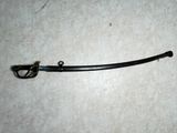 a black sword on the floor with a hook on it