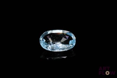 a close up of a blue diamond on a black surface
