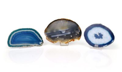 three pieces of blue and white agate on a white surface