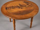 a wooden table with a picture of a farm on it