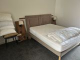 a bed that has a pillow on it in a room