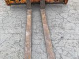 an image of a forklift truck parked in a parking lot