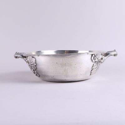 un bol ancien plaqué argent, muni d'anses, sur fond blanc