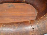 a wooden bowl with a wooden handle on a table