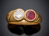 a close up of a gold ring with two ruby stones