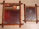 two mirrors sitting on a wooden table next to each other