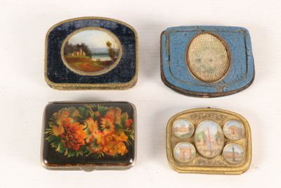 three small boxes with paintings on them are sitting on a white surface