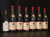 several bottles of wine are lined up on a table