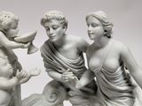 three figurines of a woman and two children
