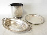 a silver plate and a silver cup on a table