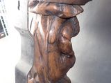 a wooden carving of a man with a hat on his head