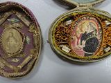 three small decorative items are sitting on a white surface