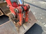a red bulldozer that is sitting in the street