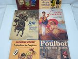 four children ' s books are lined up on a table