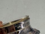 a person holding a silver object in their hand
