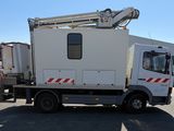a white truck with a crane on the back of it