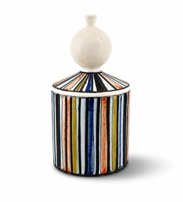 a close up of a container with a striped lid on a white background
