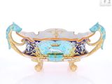 a blue and gold bowl with a fish on it