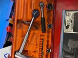 a tool box with tools in it sitting on a table