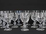 six verres à vin en cristal alignés sur une surface noire
