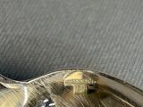 a silver spoon with a spoon rest on top of it