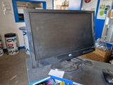 a computer monitor sitting on top of a desk