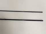 two black rods are on a white surface with a white background