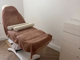 an image of a chair with a blanket on it in a room