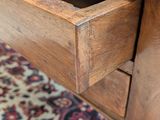 close up of a wooden table with a drawer on top of it