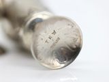 a close up of a silver object on a white surface