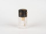 a small glass bottle with a black lid