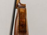 a violin that is sitting on a stand on a table