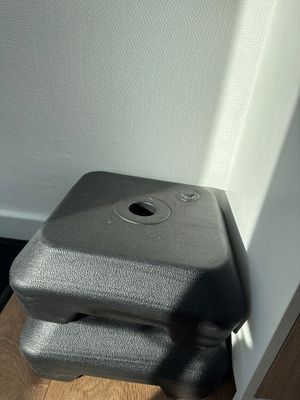 a black piece of luggage sitting on the floor next to a door