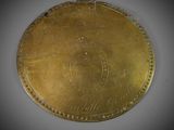 an old gold coin with a crown on it sitting on a table