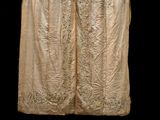 an image of a white dress with gold embroiderys