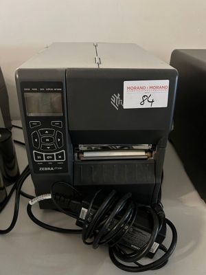 a small printer sitting on a table next to a coffee mug